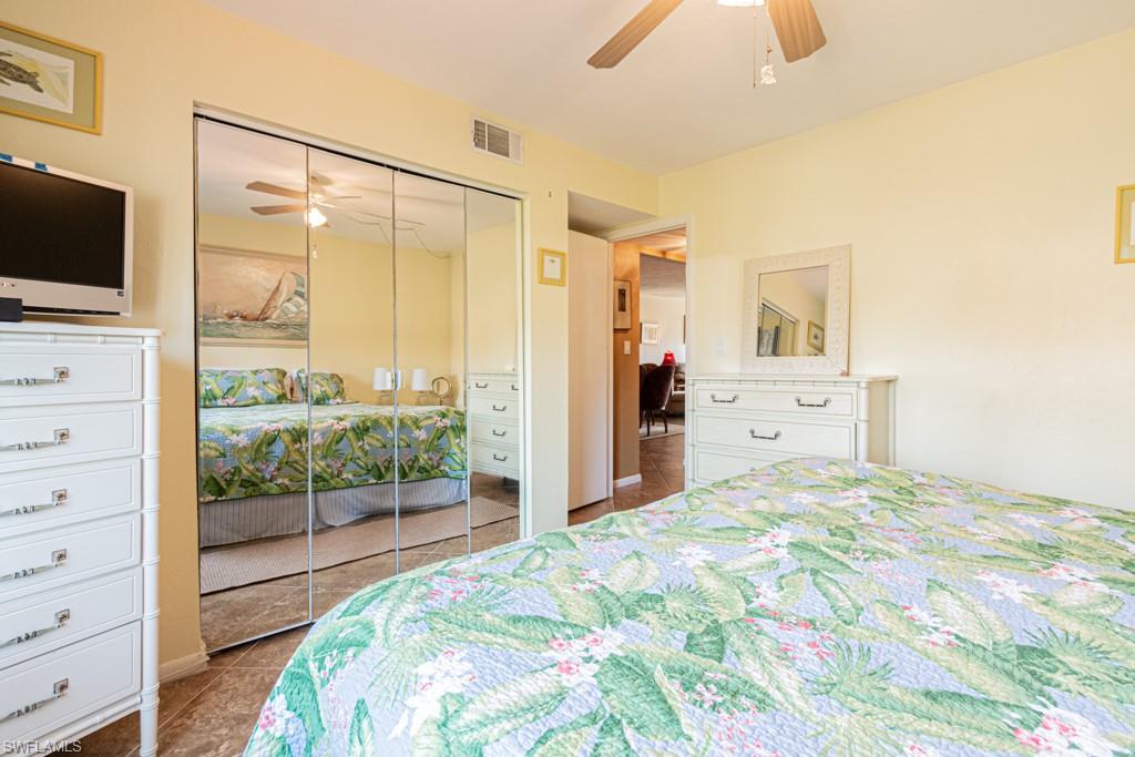 3662 Arctic Circle, Unit 201 Naples, FL 34112 - Photo 25 of 35 a bedroom with a bed and a flat tv screen on dresser