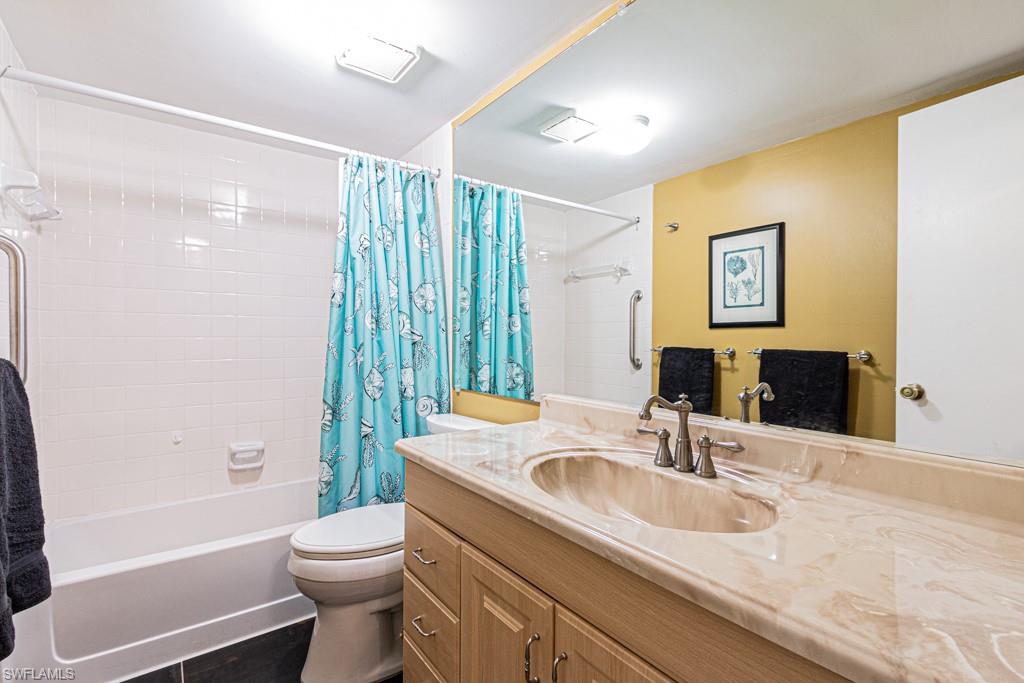 3662 Arctic Circle, Unit 201 Naples, FL 34112 - Photo 26 of 35 a bathroom with a granite countertop sink toilet and shower