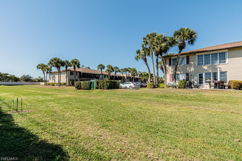 3662 Arctic Circle, Unit 201 Naples, FL 34112 - Photo 32 of 35 a front view of a building with garden