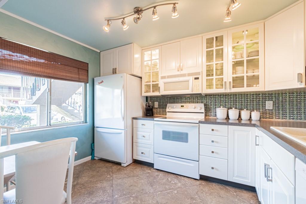 3662 Arctic Circle, Unit 201 Naples, FL 34112 - Photo 7 of 35 a kitchen with white cabinets and window