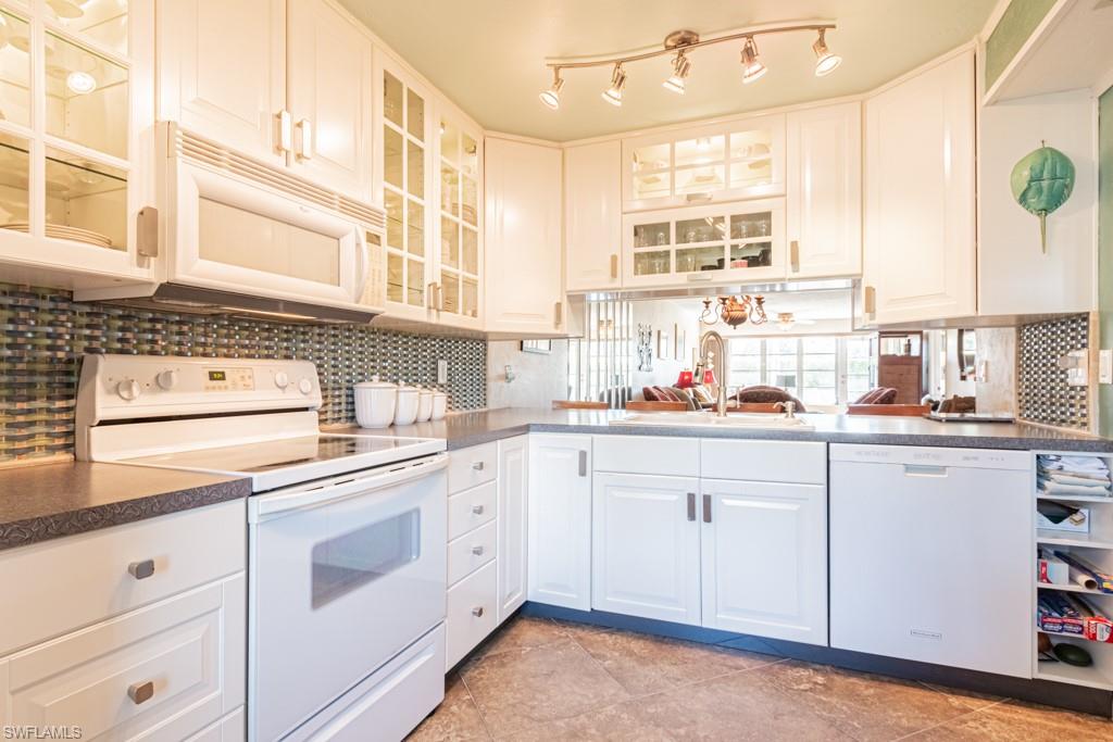 3662 Arctic Circle, Unit 201 Naples, FL 34112 - Photo 8 of 35 a kitchen with white cabinets and white appliances
