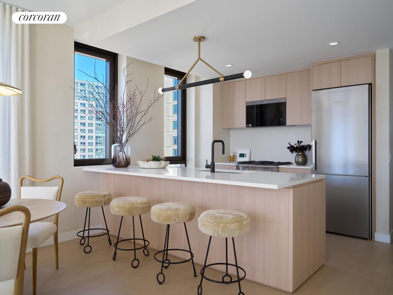 482 Kent Avenue, Unit PHB Brooklyn, NY 11249 - Photo 1 of 28 a kitchen with stainless steel appliances a sink and a refrigerator