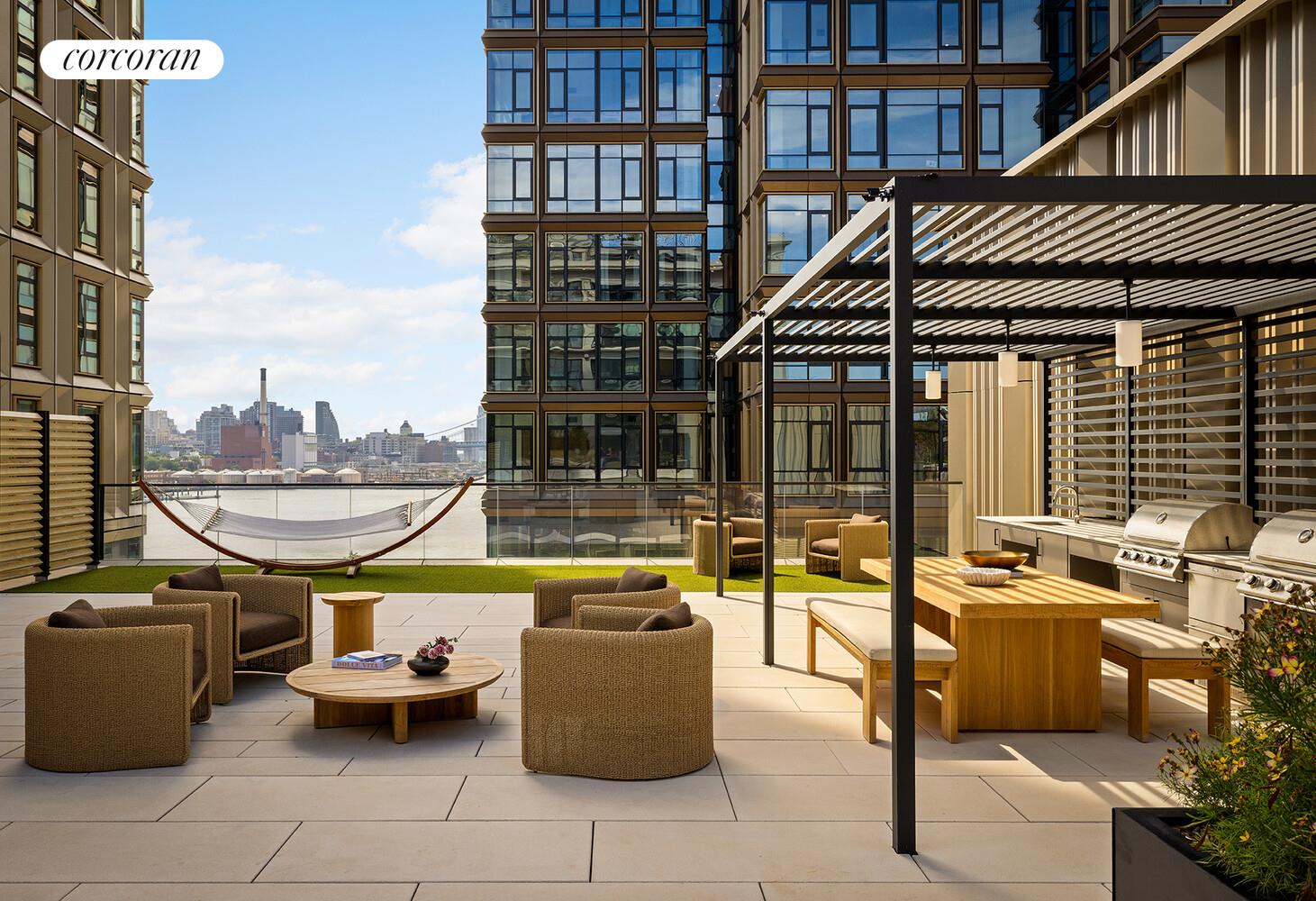 482 Kent Avenue, Unit PHB Brooklyn, NY 11249 - Photo 19 of 28 a view of a roof deck with couches and potted plants