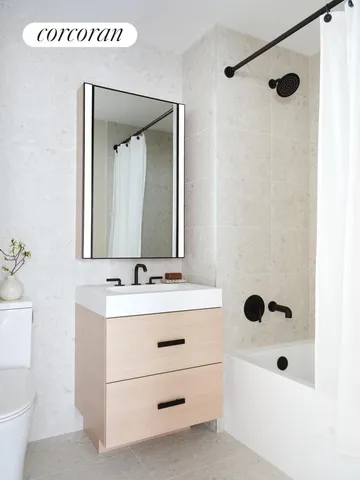a bathroom with a sink a toilet and mirror