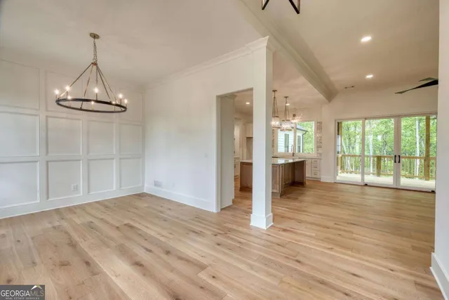 a large kitchen with stainless steel appliances a large center island attached withe living room