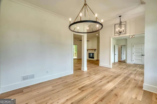 a kitchen with stainless steel appliances granite countertop a sink a stove and a wooden floors