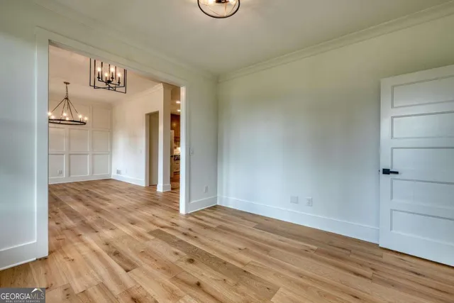 a kitchen with stainless steel appliances a stove top oven and white cabinets