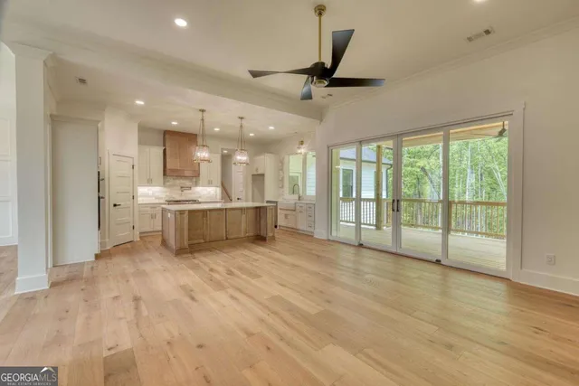 a view of empty room with wooden floor and fireplace