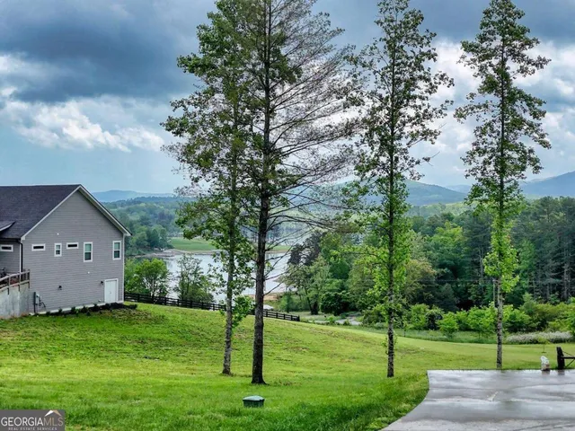 a front view of a house with a garden and yard