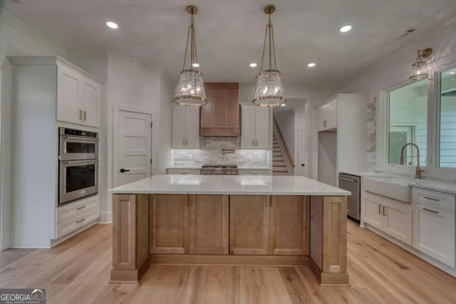 a view of an empty room with a fireplace and a window