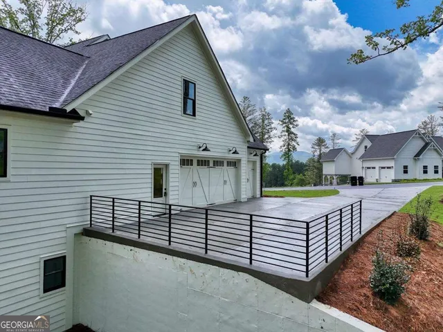 a front view of a house with a floor to ceiling window and shower