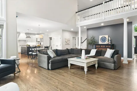 a living room with furniture or kitchen view and a wooden floor