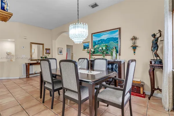 a living room with furniture and a dining table with kitchen view