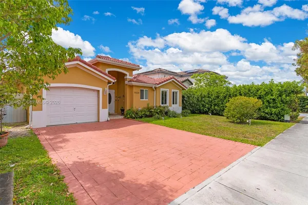a front view of a house with a yard and garage