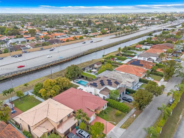 an aerial view of residential houses with outdoor space