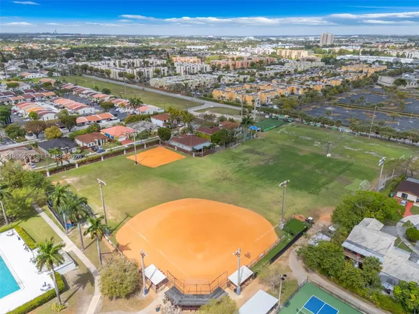 an aerial view of residential houses with outdoor space