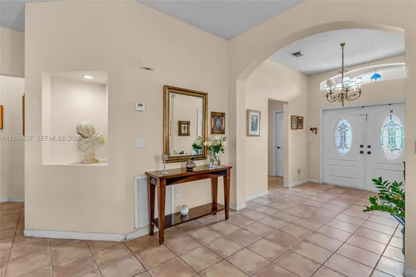 a living room with furniture a couch and a chandelier