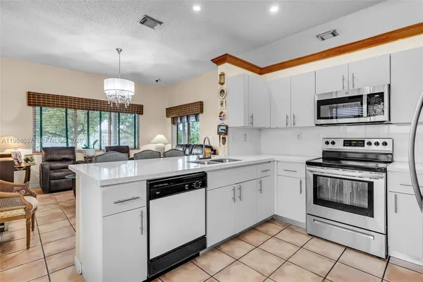 a kitchen that has a sink and a stove