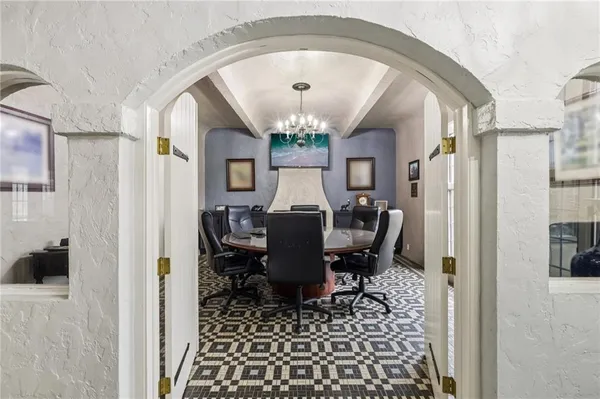 a view of a dining room with furniture and a chandelier