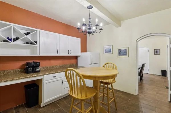 a dining room with a sink and chandelier