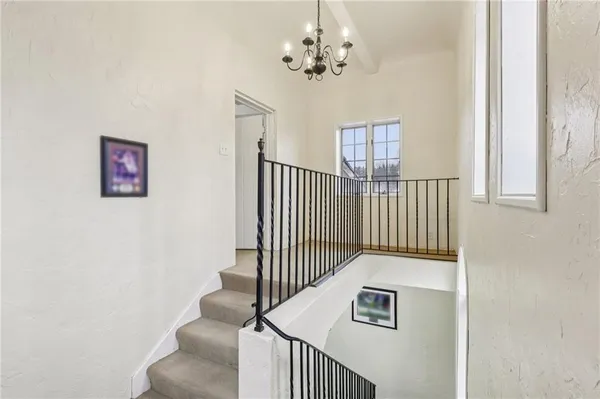 a view of entryway and hall with a chandelier