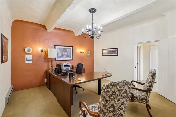 a view of a workspace with furniture and a chandelier