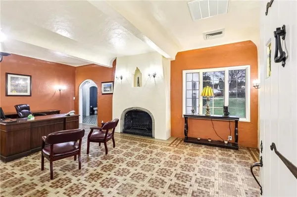 a living room with furniture and a fireplace