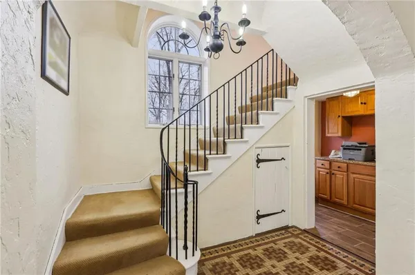 a view of entryway and hall with wooden floor