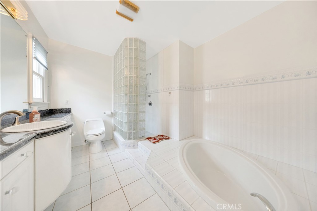 2835 Devonport Road San Marino, CA 91108 - Photo 33 of 54 a bathroom with a granite countertop sink a toilet and bathtub