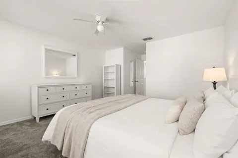 a bedroom with a bed and a window