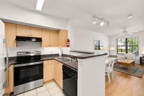 a kitchen with stainless steel appliances a stove sink and cabinets