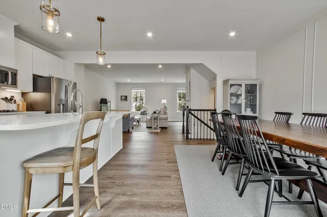 a dining room with furniture and wooden floor