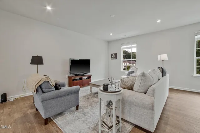 a living room with furniture and a view of kitchen