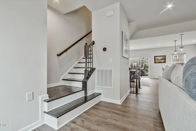 a spacious bedroom with a bed and a lamp