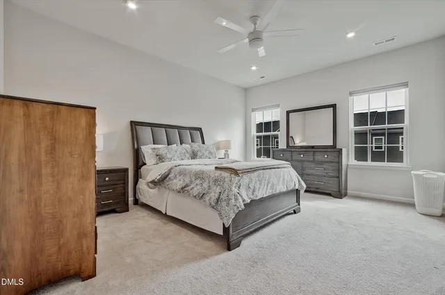 a bedroom with a large bed and a chandelier