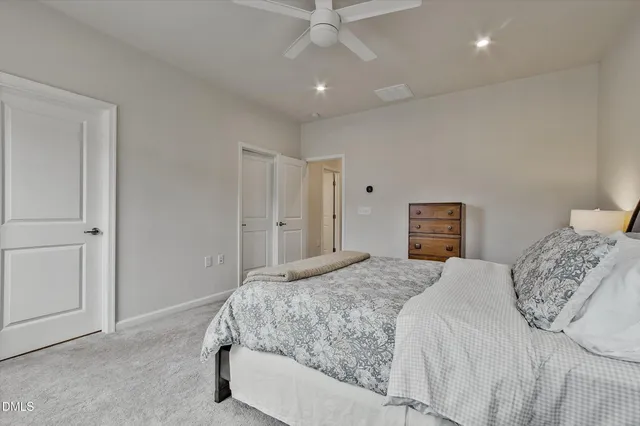 a bedroom with a large bed and a dresser