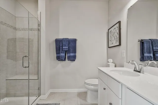 a bathroom with a shower a toilet and sink