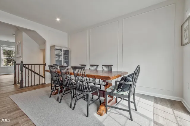 a view of a dining room and livingroom with furniture wooden floor and a rug