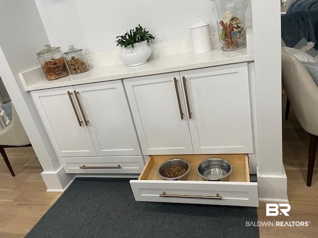 32937 River Road Orange Beach, AL 36561 - Photo 11 of 42 Room details with wood-type flooring and white cabinetry