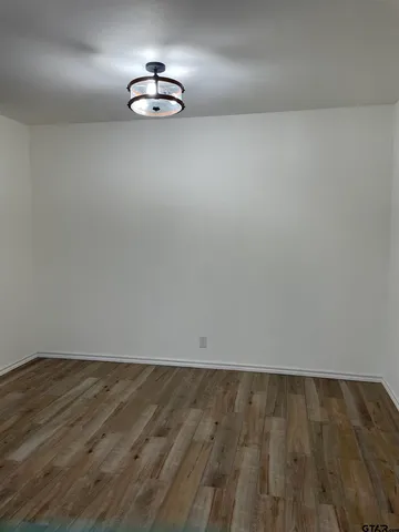 a view of a kitchen with white cabinets