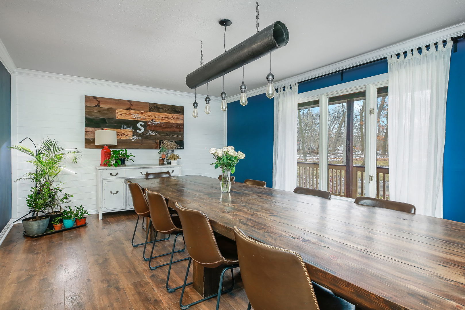 31W137 Rohrssen Road Hoffman Estates, IL 60192 - Photo 13 of 43 a dining room with furniture potted plants and wooden floor
