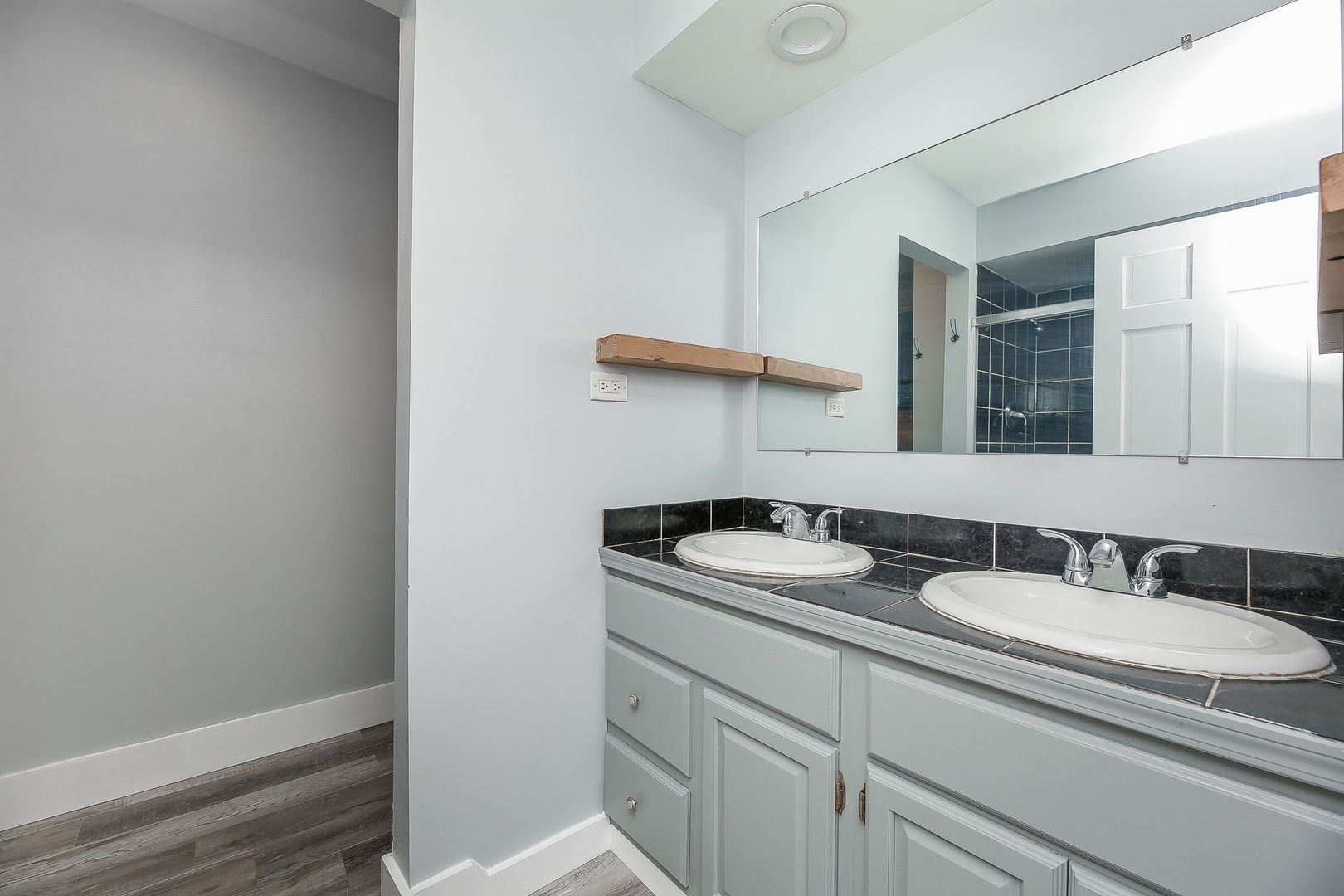 31W137 Rohrssen Road Hoffman Estates, IL 60192 - Photo 17 of 43 a bathroom with a sink and a mirror