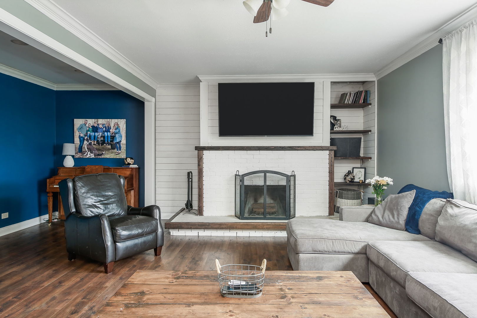 31W137 Rohrssen Road Hoffman Estates, IL 60192 - Photo 5 of 43 a living room with furniture a flat screen tv and a fireplace