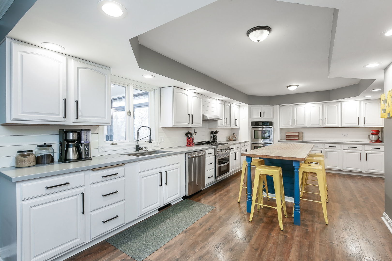 31W137 Rohrssen Road Hoffman Estates, IL 60192 - Photo 9 of 43 a kitchen with white cabinets and sink
