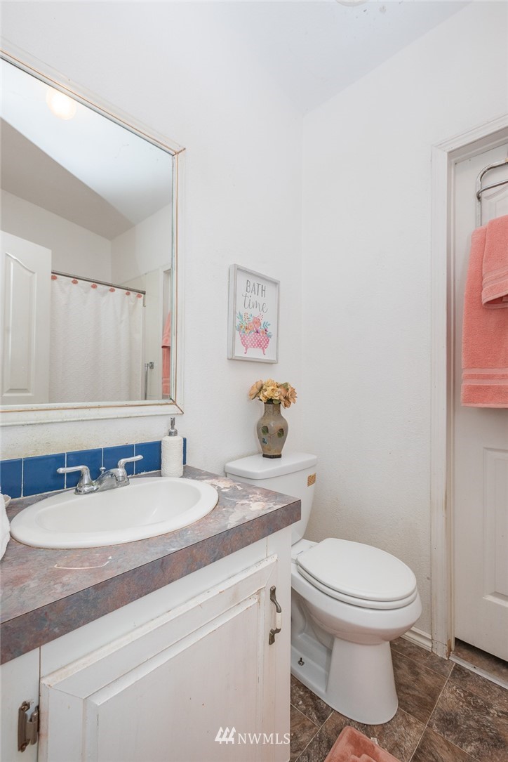 2011 Bishop Road Chehalis, WA 98532 - Photo 11 of 25 a bathroom with a granite countertop sink mirror vanity and toilet