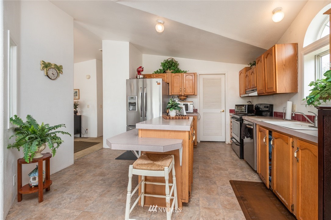 2011 Bishop Road Chehalis, WA 98532 - Photo 8 of 25 a kitchen with furniture a counter top space stainless steel appliances and cabinets