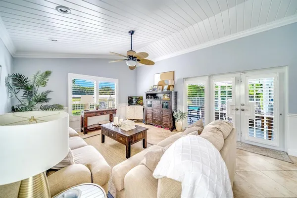 a living room with furniture ceiling fan and a window