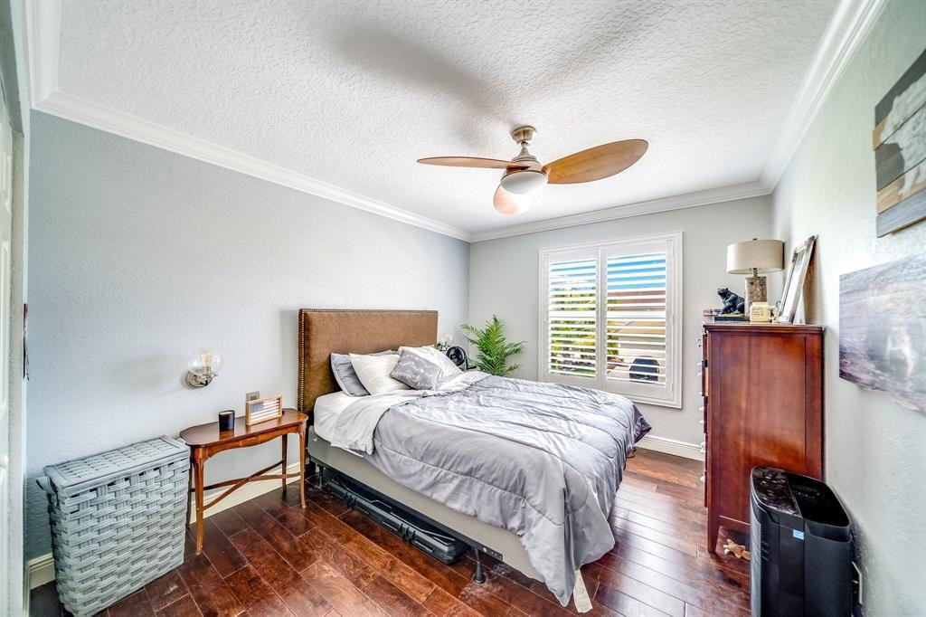 12036 Quilting Lane Boca Raton, FL 33428 - Photo 14 of 25 a bedroom with a bed and a chandelier