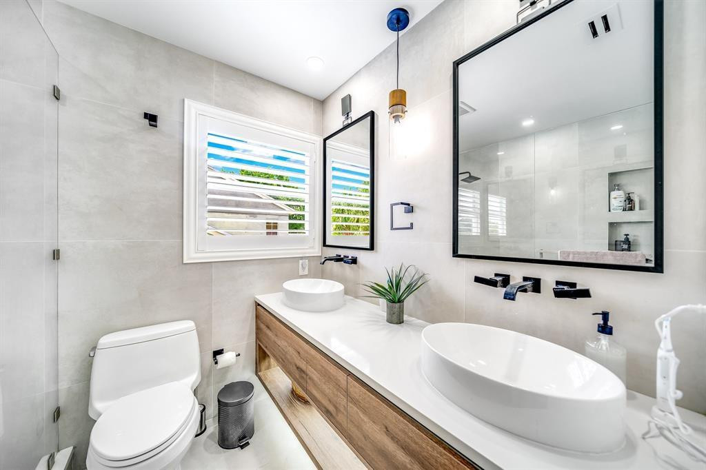 12036 Quilting Lane Boca Raton, FL 33428 - Photo 16 of 25 a bathroom with a granite countertop sink mirror and a toilet