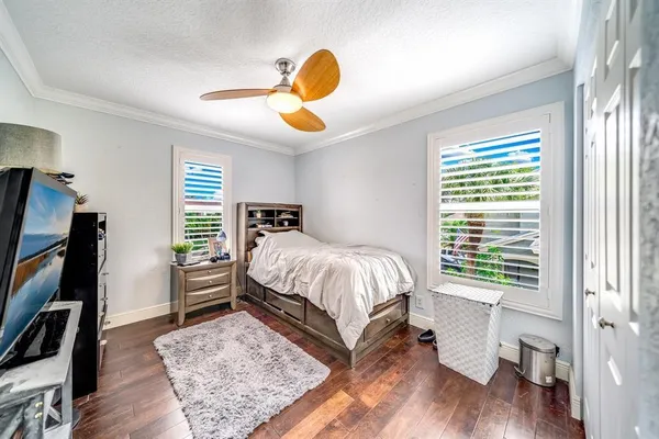a bedroom with a bed and a large window